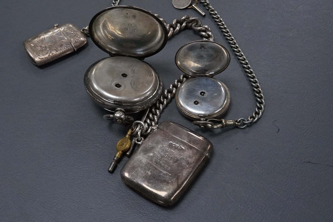 A late Victorian silver open faced key wind pocket watch, with Roman dial and subsidiary seconds, case diameter 52mm, on a heavy silver curb link albert, hung with a silver vesta case and a watch key, together with a con